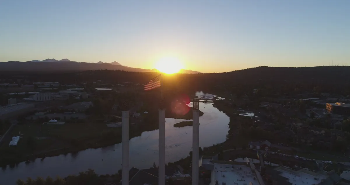 Wide aerial view of Bend, Oregon with the Old Mill smokestacks and river